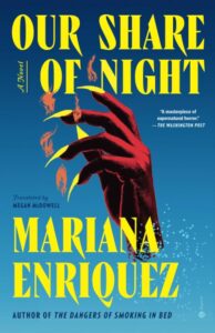 The photo is the cover image of Mariana Enriquez's novel Our Share of Night. The cover image is of a hand with long, talon-like fingernails attached to the hand's slim fingers. The fingers are bent, which makes the hand look as if it is grabbing for something that we can't see.