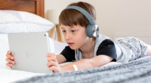 Child in front of computer pad.